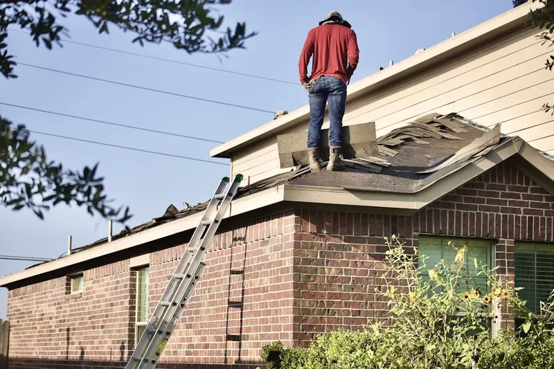 Professional roofer working on a residential roof in Lupine Village